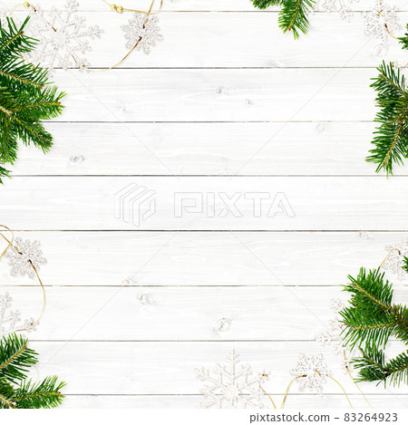 White wooden wall with fir tree and snow ornaments White wooden wall with fir tree and snow ornaments 83264923