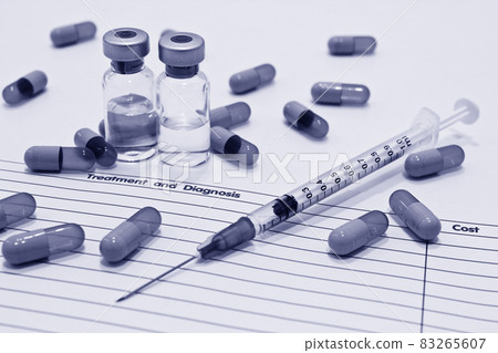 Vial of drugs or vaccine, 1 ml plastic syringe with needle, drug capsule and OPD card isolated on the white background 83265607