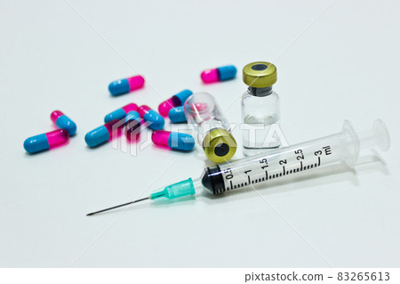 Vial of drugs or vaccine, 3 ml plastic syringe with needle and drug capsule isolated on the white background Vial of drugs or vaccine, 3 ml plastic syringe with needle and drug capsule isolated on the white background 83265613