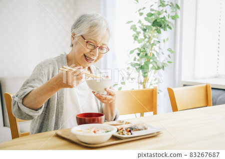 Elderly woman eating 83267687