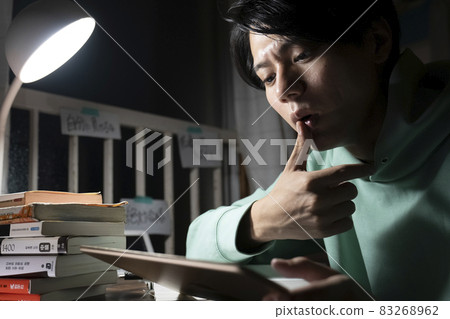A man studying all night A man studying all night 83268962