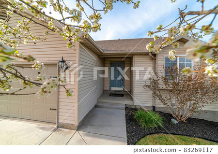 Front door entrance and attached garage at the facade of home with beige wall Front door entrance and attached garage at the facade of home with beige wall 83269117