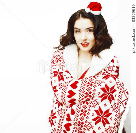 young pretty happy smiling woman on christmas in santas red hat posing isolated on white background, lifestyle people concept 83269610