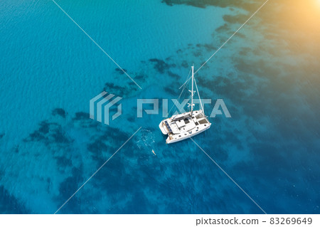 Catamaran yacht near the rocky coast in Turkey. Luxury vacation at sea 83269649