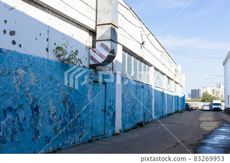 shabby painted walls of warehouse in morning 83269953