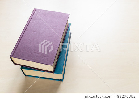two thick volumes of books on light board two thick volumes of books on light board 83270392