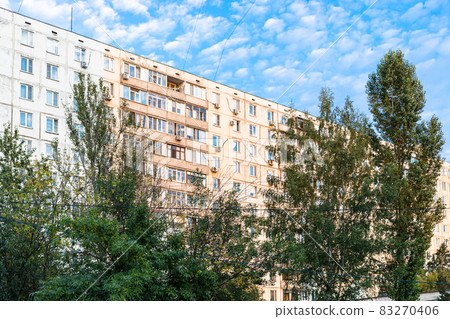sunlit residential multi-storey building and trees sunlit residential multi-storey building and trees 83270406