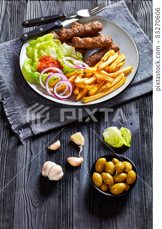 cevapcici with potato fries, lettuce, onion, ajvar 83270606