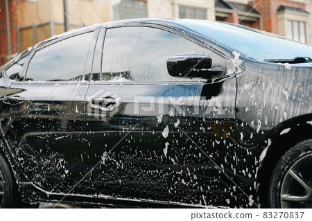 Modern car covered by foam. Car wash. 83270837