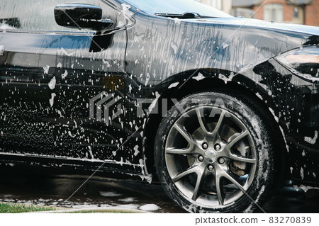 Modern car covered by foam. Car wash. 83270839