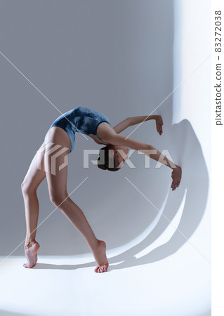 Young and graceful ballet dancer, ballerina dancing isolated on light studio background. Art, motion, action, flexibility, inspiration concept. Young and graceful ballet dancer, ballerina dancing isolated on light studio background. Art, motion, action, flexibility, inspiration concept. 83272038