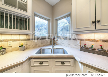 Corner vanity sink inside a kitchen with granite top Corner vanity sink inside a kitchen with granite top 83272376
