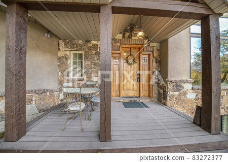 Front door exterior of a house with half stone sidings Front door exterior of a house with half stone sidings 83272377