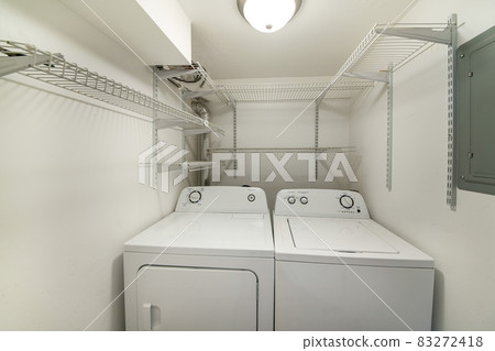 White laundry room with shelves with adjustable brackets. White laundry room with shelves with adjustable brackets. 83272418