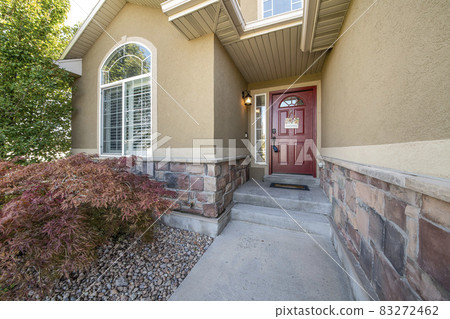 Front exterior of a house with half stone wall siding Front exterior of a house with half stone wall siding 83272462