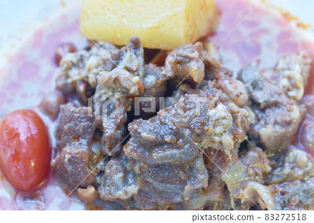 beef curry with slice potato and tomato on plate beef curry with slice potato and tomato on plate 83272518