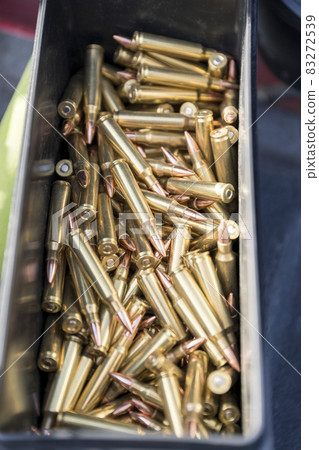 Copper bullets 223 ammo of a rifle inside a black container Copper bullets 223 ammo of a rifle inside a black container 83272539