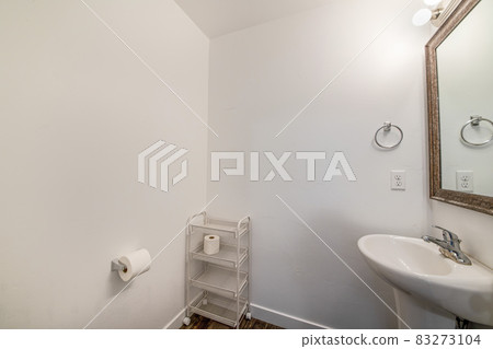 Wheel-mounted rack inside a bathroom with toilet paper Wheel-mounted rack inside a bathroom with toilet paper 83273104