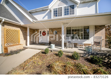 Exterior of a house with messy front yard garden and bricks Exterior of a house with messy front yard garden and bricks 83273126