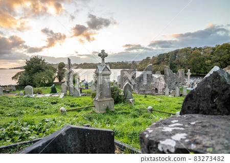 The sun is setting above the Abbey Graveyard which was build by Hugh O Donnell in 1474 - all names and artwork removed 83273482