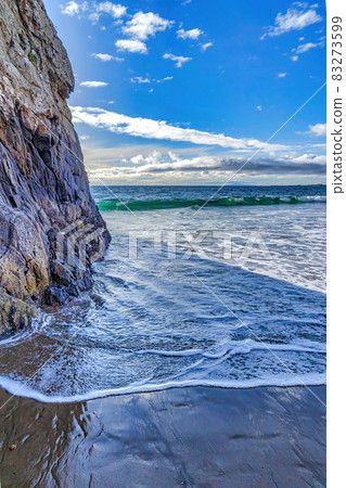 Ocean and foamy waves with rocky mountain in Laguna Beach California landscape Ocean and foamy waves with rocky mountain in Laguna Beach California landscape 83273599