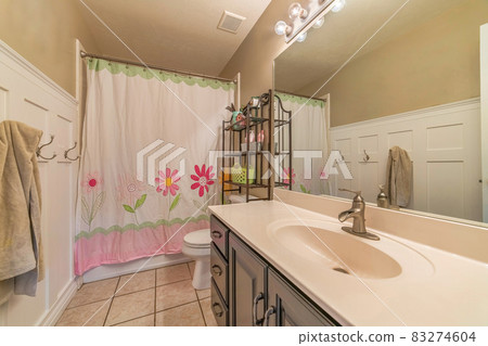 Bathroom interior of home with floral shower curtain concealing the bathtub 83274604