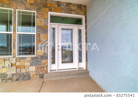 Elegant glass front door with sidelights and transom window at house facade 83275541