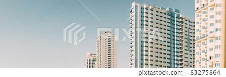 Wall With A Balcony Of New Empty Modern Multi-storey Residential Building House In Residential Area On Blue Sky. Panorama, Panoramic View Wall With A Balcony Of New Empty Modern Multi-storey Residential Building House In Residential Area On Blue Sky. Panorama, Panoramic View 83275864