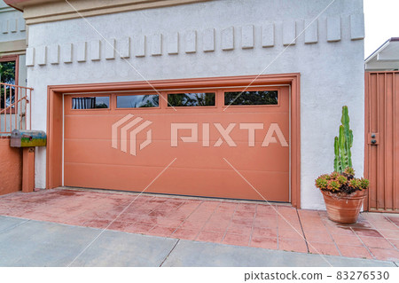 Garage of house in San Diego california with glass panes on the wide brown door Garage of house in San Diego california with glass panes on the wide brown door 83276530