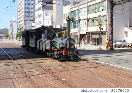 Bocchan train going at level crossing Iyo Railway Matsuyama City Ehime Prefecture Shikoku Bocchan train going at level crossing Iyo Railway Matsuyama City Ehime Prefecture Shikoku 83276900
