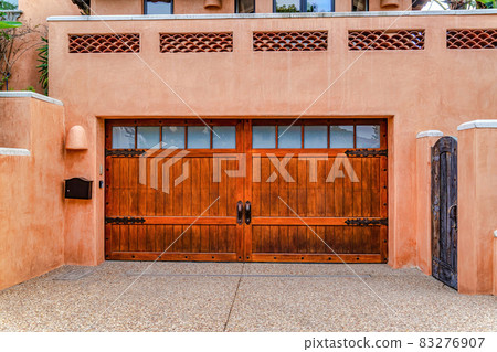 Home with balcony above garage against peach wall in San Diego California Home with balcony above garage against peach wall in San Diego California 83276907