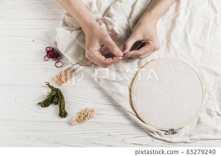 hand holding needle thread tambour frame. High quality and resolution beautiful photo concept 83279240