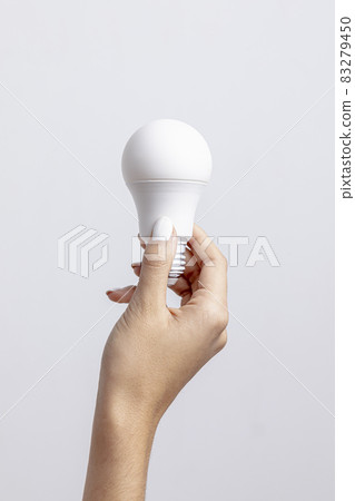 front view hand holding light bulb with copy space. High quality and resolution beautiful photo concept 83279450
