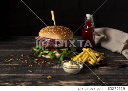 high angle burger with fries sauces table. High quality and resolution beautiful photo concept high angle burger with fries sauces table. High quality and resolution beautiful photo concept 83279619