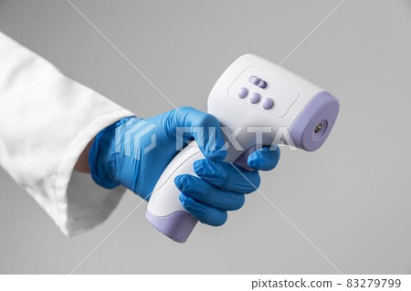 doctor with gloves holding thermometer. High quality and resolution beautiful photo concept doctor with gloves holding thermometer. High quality and resolution beautiful photo concept 83279799