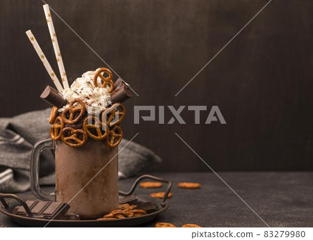 front view chocolate milkshake with straws pretzels. High quality and resolution beautiful photo concept front view chocolate milkshake with straws pretzels. High quality and resolution beautiful photo concept 83279980