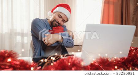 hipster man with red cup sitting home at Christmas time. hipster man with red cup sitting home at Christmas time. 83280981