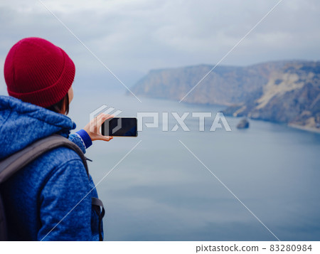 woman take photo of sea on smartphone woman take photo of sea on smartphone 83280984
