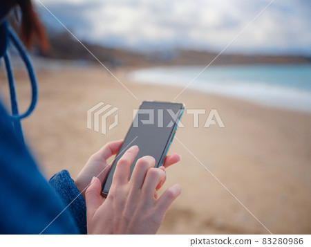 woman take photo of sea on smartphone woman take photo of sea on smartphone 83280986