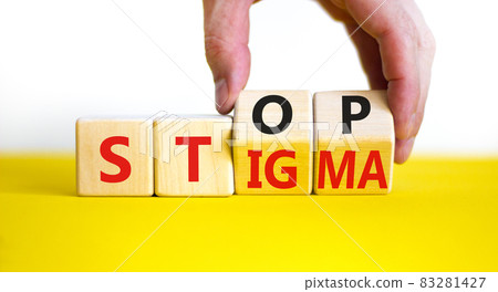 Stop stigma symbol. Doctor turns wooden cubes with words stop stigma. Beautiful yellow table, white background. Medical and stop stigma concept. Copy space. 83281427