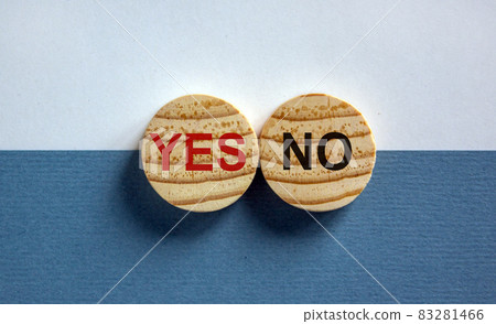 Wood circles with words 'yes, no' on paper white and blue background, copy space. Business concept. Wood circles with words 'yes, no' on paper white and blue background, copy space. Business concept. 83281466