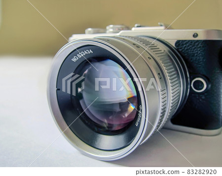 A mirrorless camera with interchangeable-lens  large aperture lens. 83282920