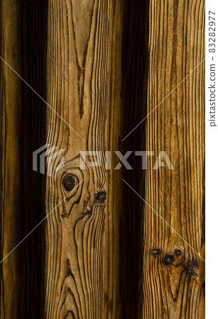 Background of an old natural wooden gradient darken interesting fence of beech texture inside vintage, retro proper vertical warm rural interior 83282977
