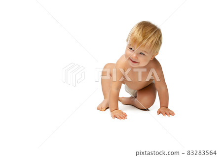 Portrait of little cute toddler boy, baby in diaper crawling isolated over white studio background 83283564