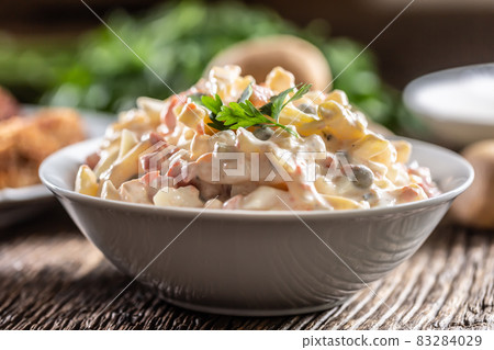 Traditional potato salad with vegetables and mayonnaise Traditional potato salad with vegetables and mayonnaise 83284029
