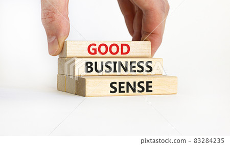 Good business sense symbol. Concept words 'Good business sense' on wooden blocks. Businessman hand. Beautiful white background. Copy space. Business and good business sense concept. 83284235
