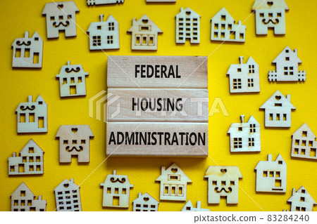 Wooden blocks form the words 'federal housing administration', miniature wooden houses. Beautiful yellow background, copy space. Business concept. Wooden blocks form the words 'federal housing administration', miniature wooden houses. Beautiful yellow background, copy space. Business concept. 83284240