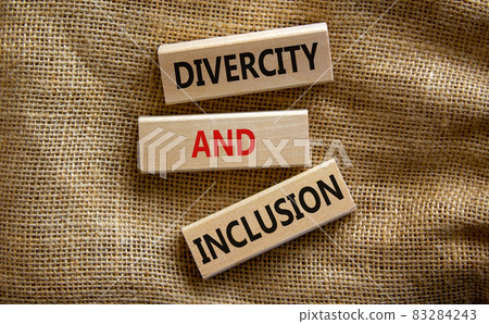 Wooden blocks form the text 'divercity and inclusion' on beautiful canvas background. Concept. 83284243