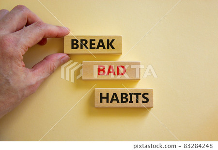 Break bad habits symbol. Wooden blocks with words 'break bad habits'. Businessman hand. Beautiful white background, copy space. Business, psychological and break bad habits concept. 83284248