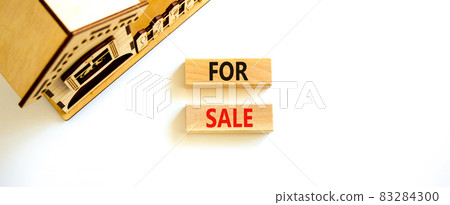 House for sale symbol. Concept words 'For sale' on wooden blocks near miniature house. Beautiful white background, copy space. Business and house for sale concept. House for sale symbol. Concept words 'For sale' on wooden blocks near miniature house. Beautiful white background, copy space. Business and house for sale concept. 83284300
